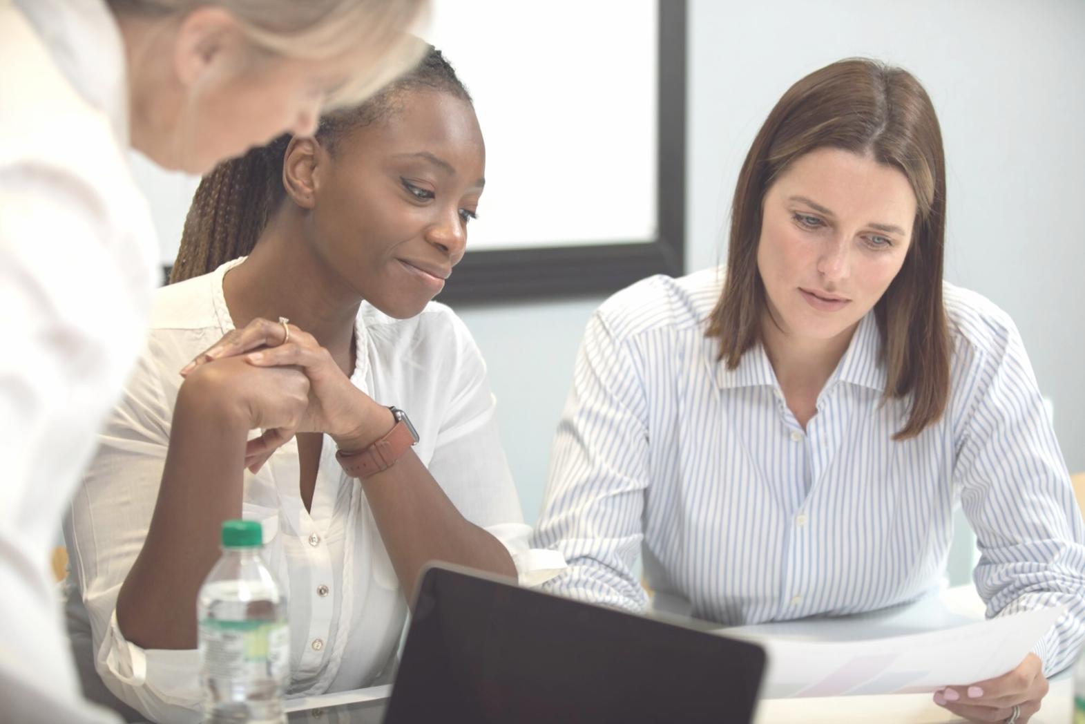 Professional reviewing budget reports and financial analysis documents